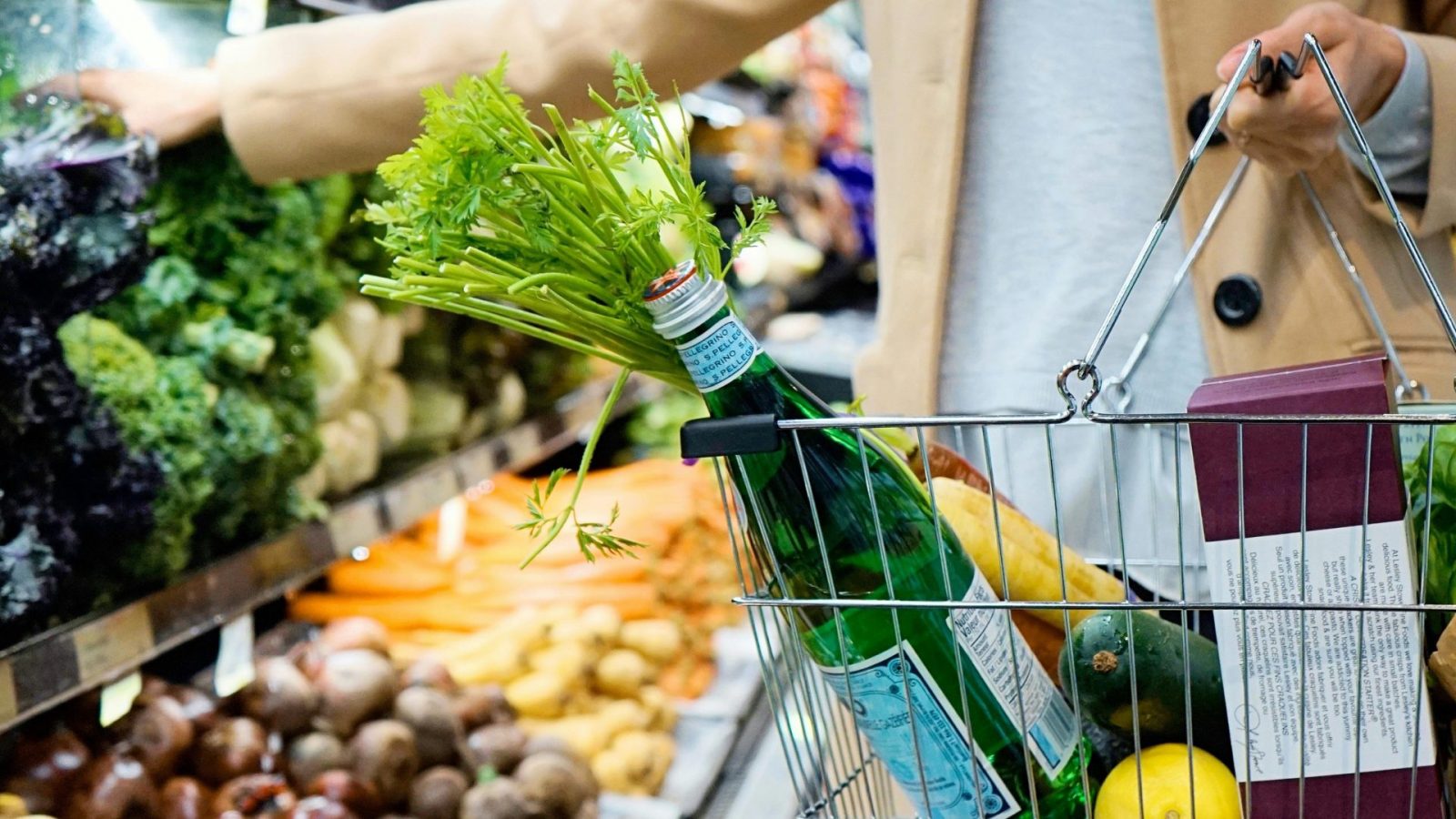 A person holding a basket in supermarket