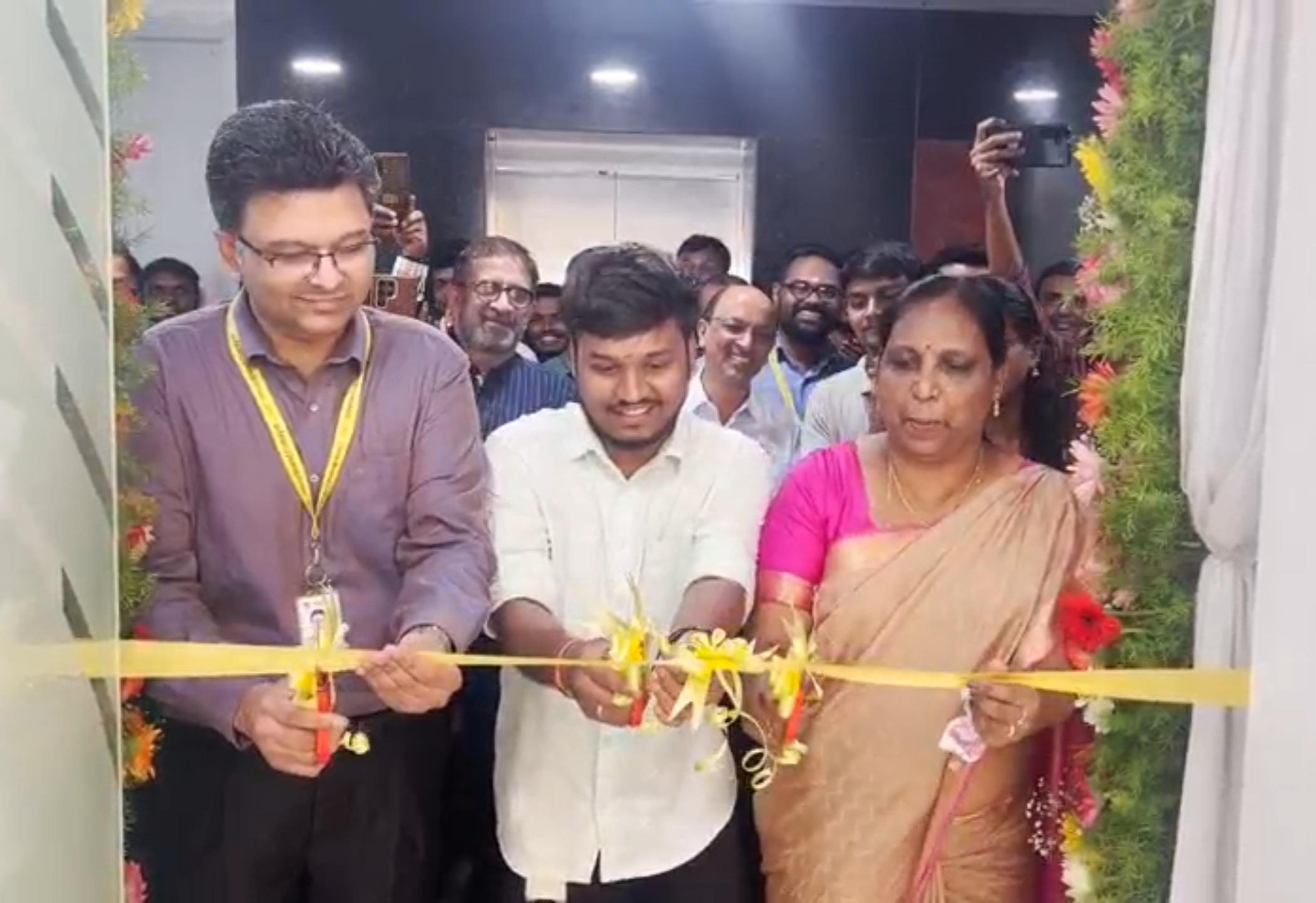 Three Sun Branding employees cutting the ribbon at the office launch
